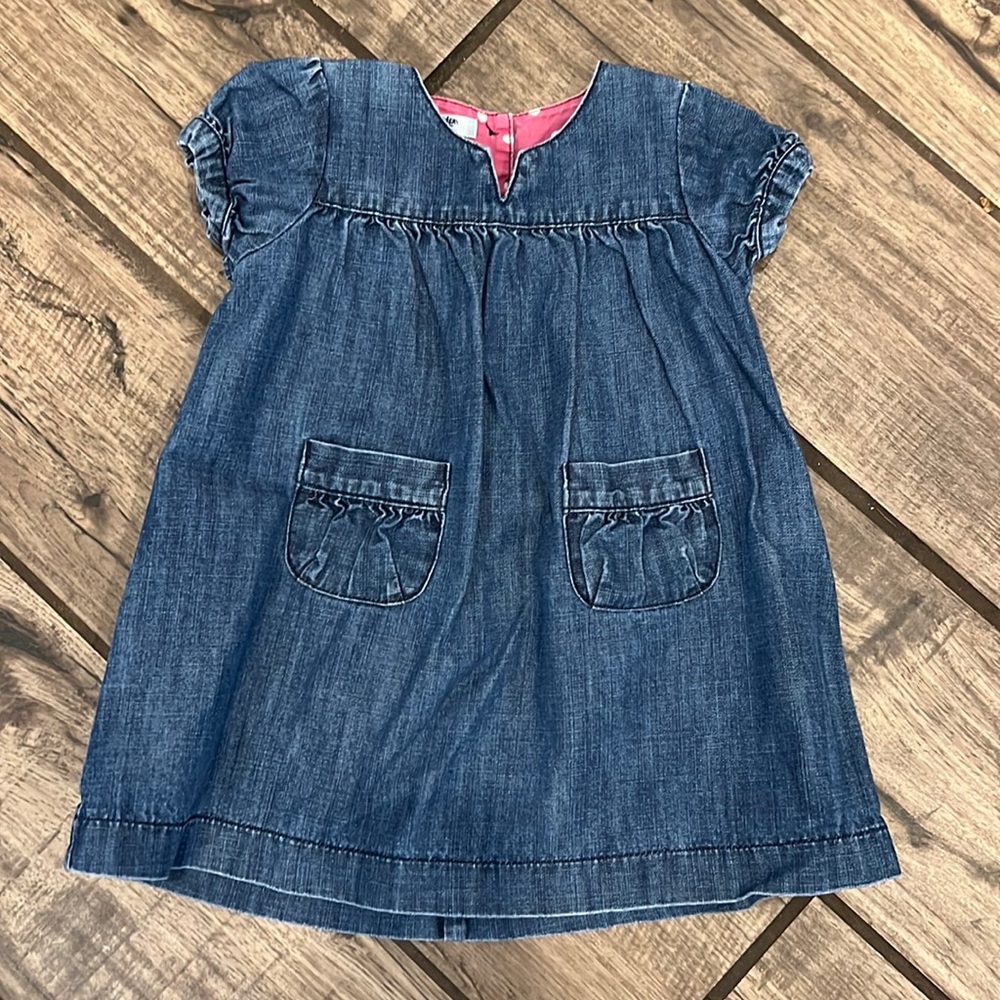 Baby Boden denim dress with front pockets.